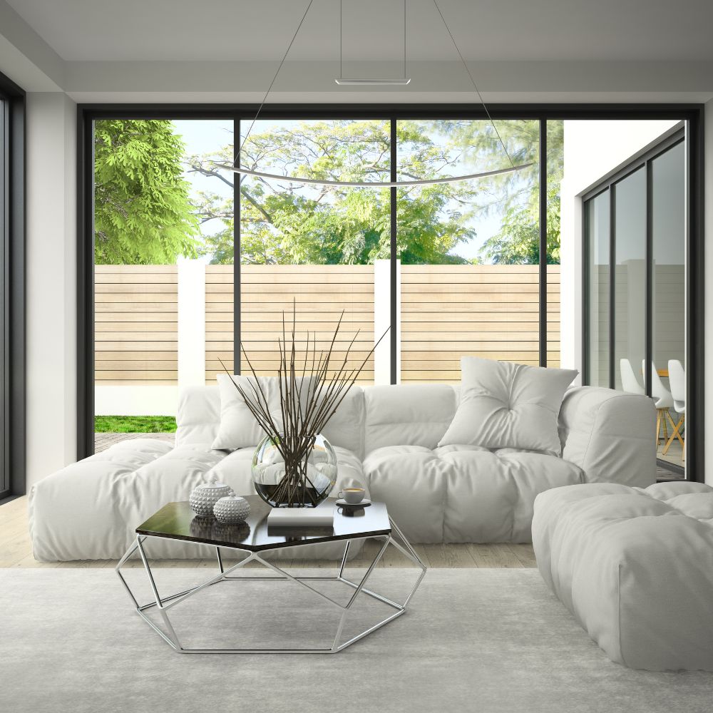 A white plush corner sofa adorns a floor to ceiling glass window home extension in Edinburgh